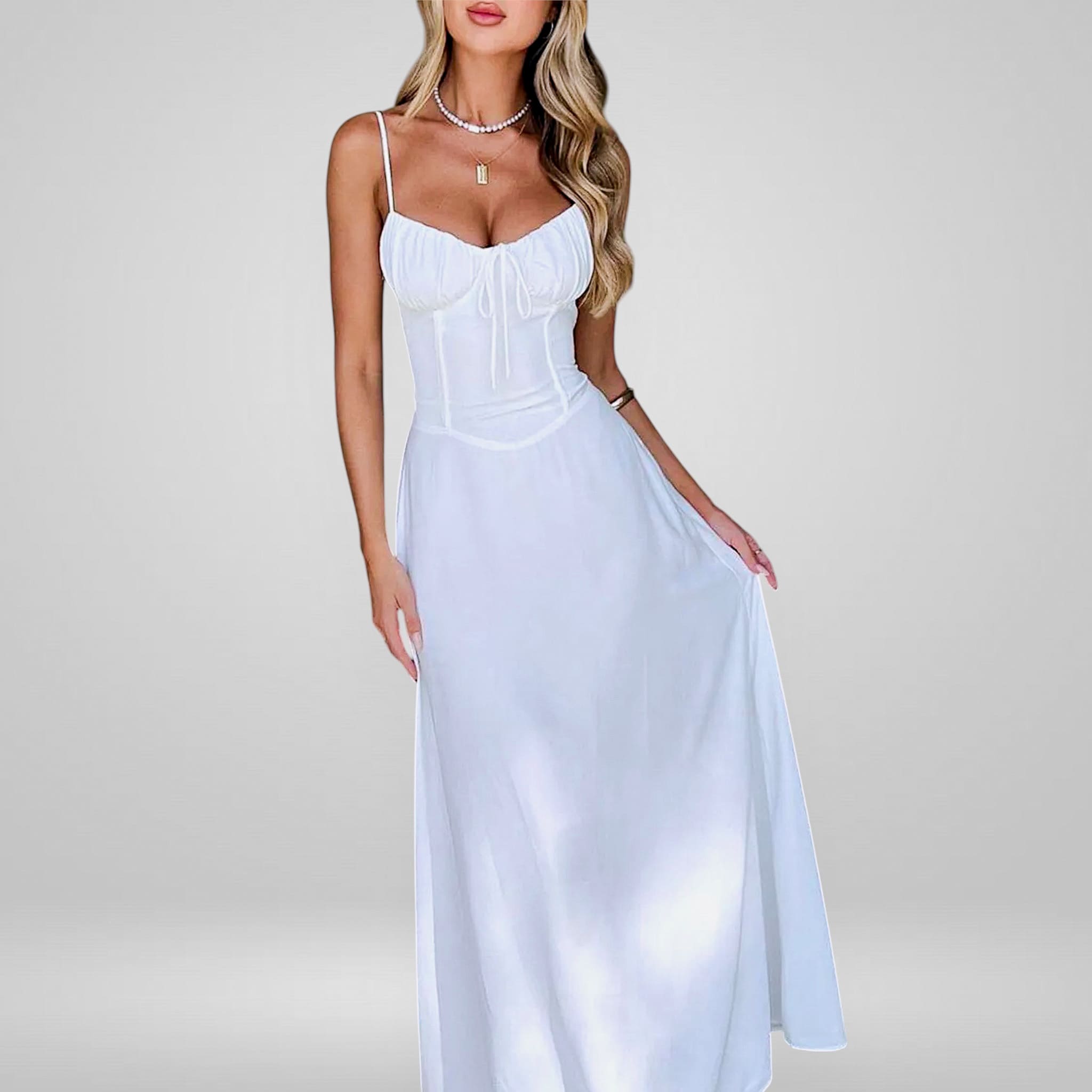 Woman wearing a white dress on a plain background