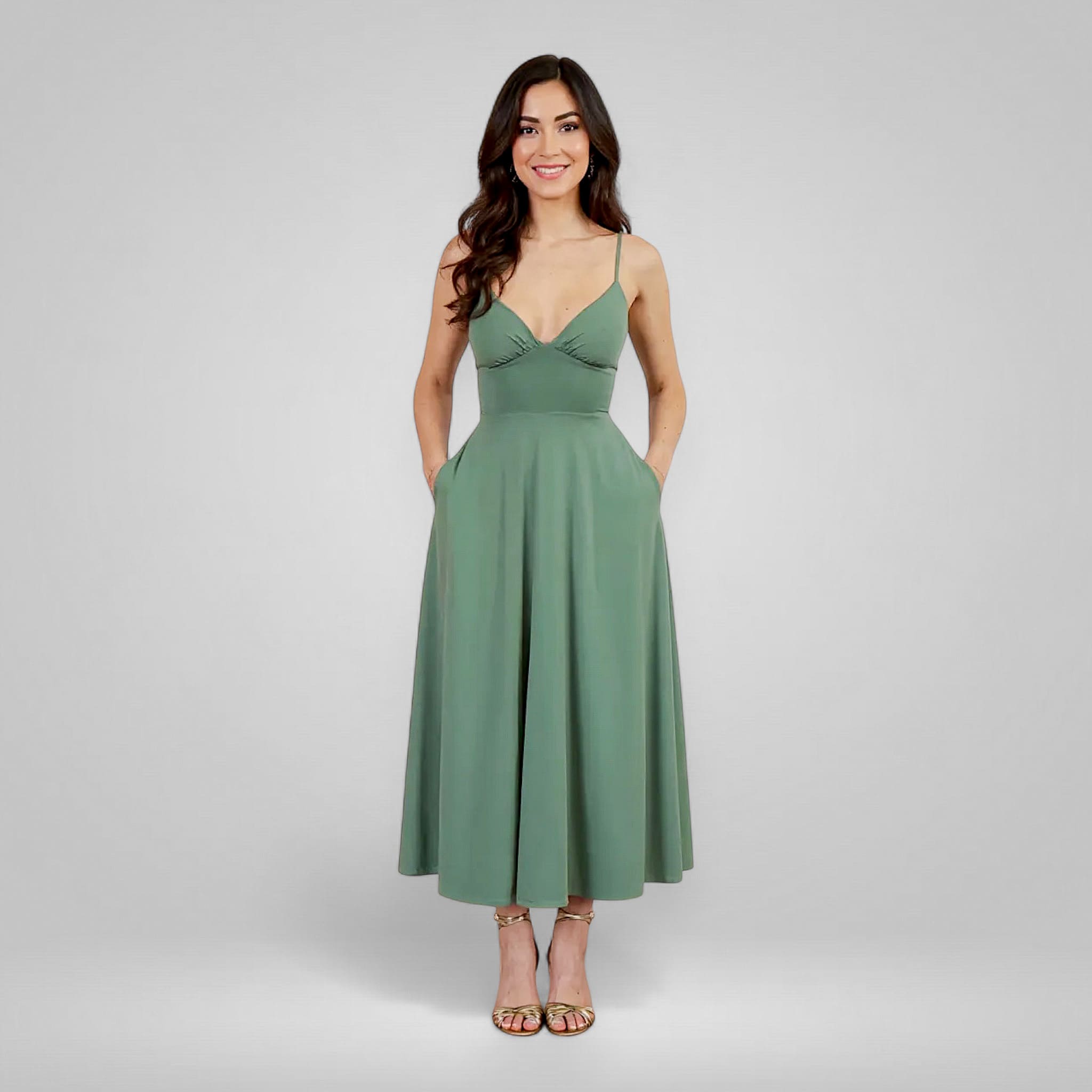 Woman wearing a green dress on a gray background