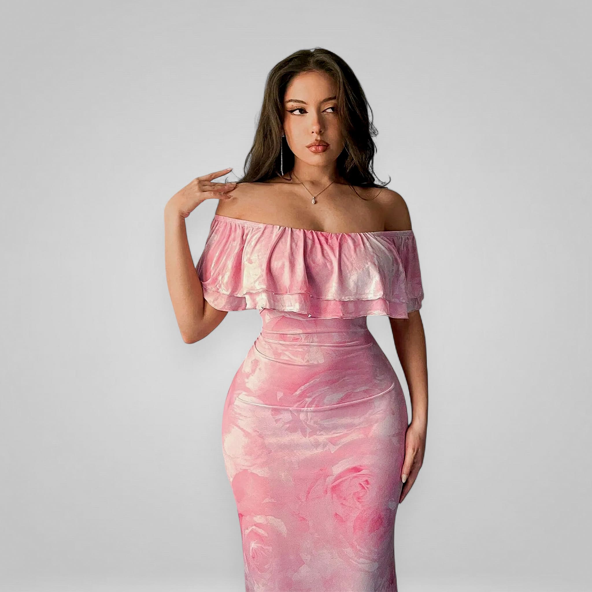 Woman wearing a pink off-shoulder dress against a plain background