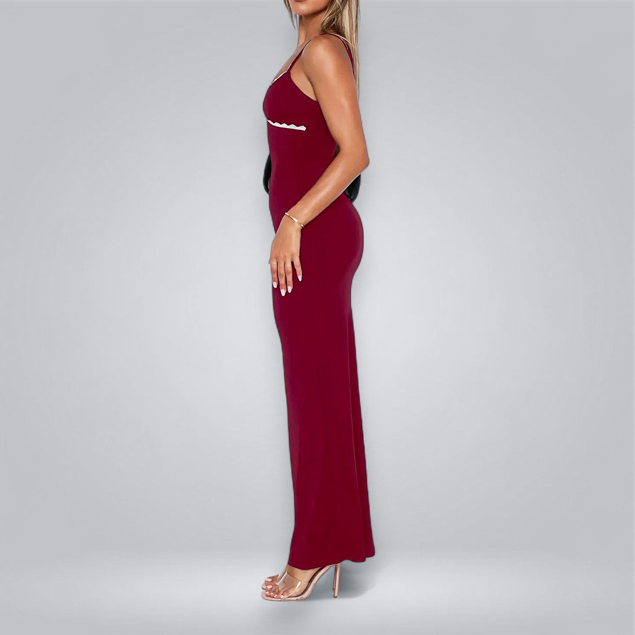 Woman wearing a burgundy dress on a gray background